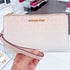 Cartera de mano y billetera Michael Kors Jet Set porta telefono logo monograma rosa